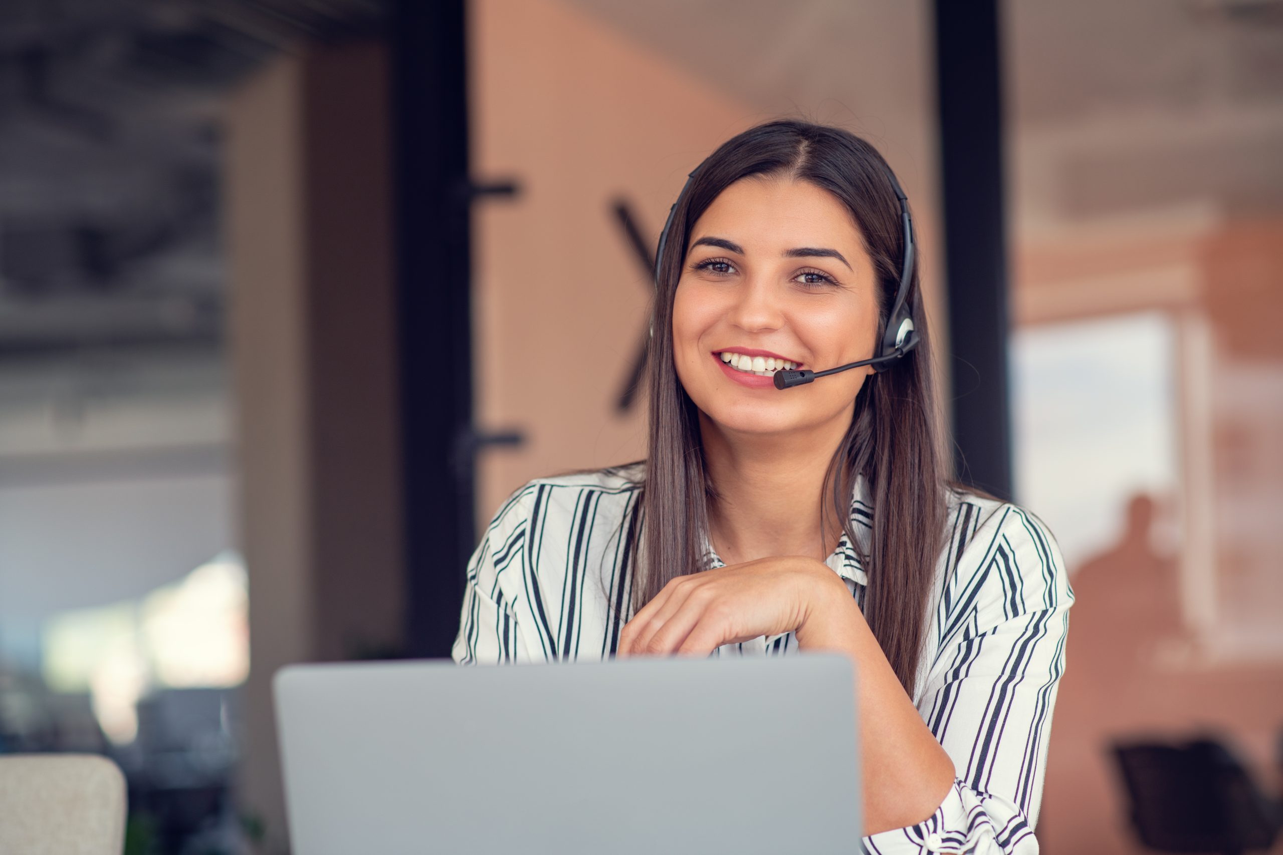 Friendly customer advisor on a headset offering Worktop Refinishing advice for oak hardwood kitchen worktops in Stanmore.