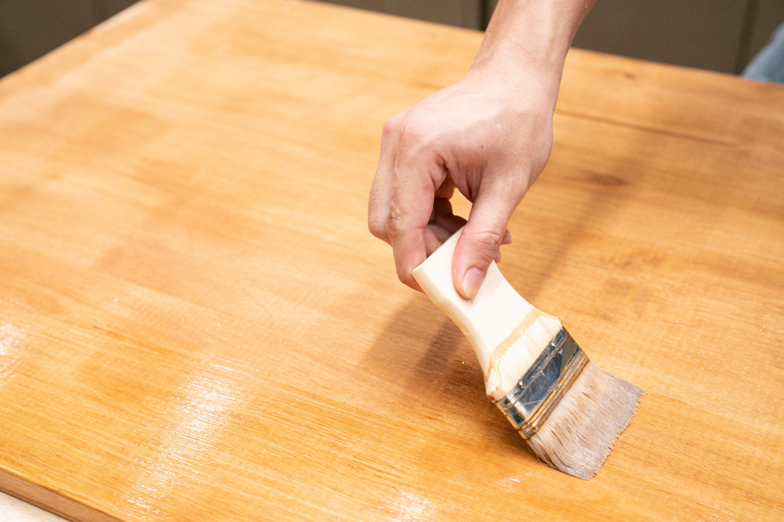 Worktop Refinishing on Oak Hardwood Kitchen Worktop in Stanmore Hand applying fresh clear oil during Worktop Refinishing on an oak hardwood kitchen worktop in a busy Stanmore home.